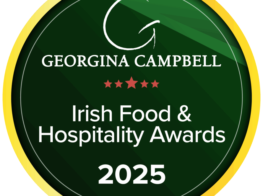 A circular green and gold badge with the text: "Georgina Campbell Irish Food & Hospitality Awards 2025" and five red stars in the centre.